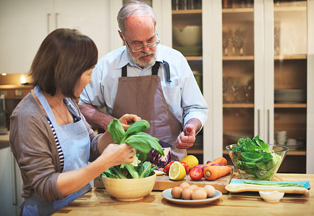 istock Couple Helping Cooking Preparation Concept 500535478
