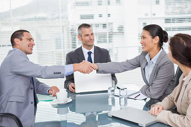 istock Smiling business people shaking hands 500535801
