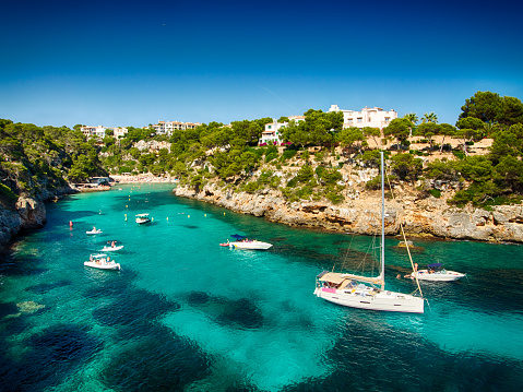 In this photo you can see the blue sea of Majorca with some recreative boats.
