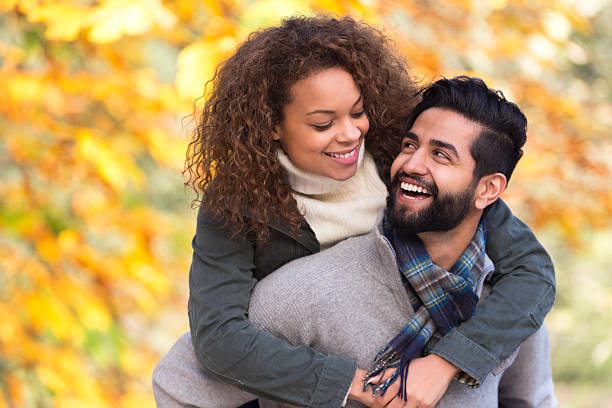 istock Mixed Race Couple Giving Each Other Piggy Backs 500537261