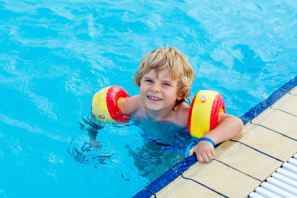 istock little boy having fun in an swimming pool 500539316