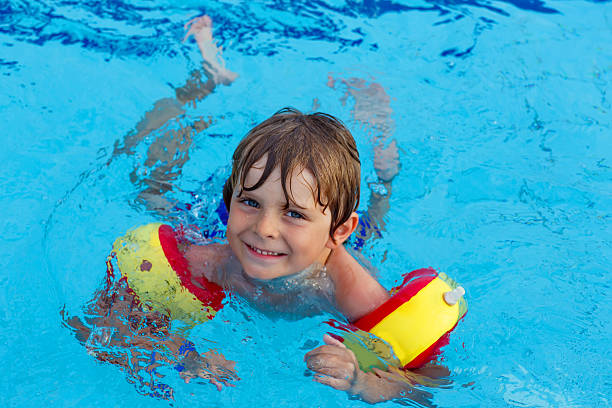 istock little boy having fun in an swimming pool 500539416