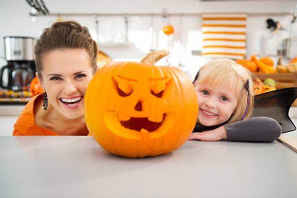 istock Funny mother with daughter in Halloween decorated kitchen 500540548