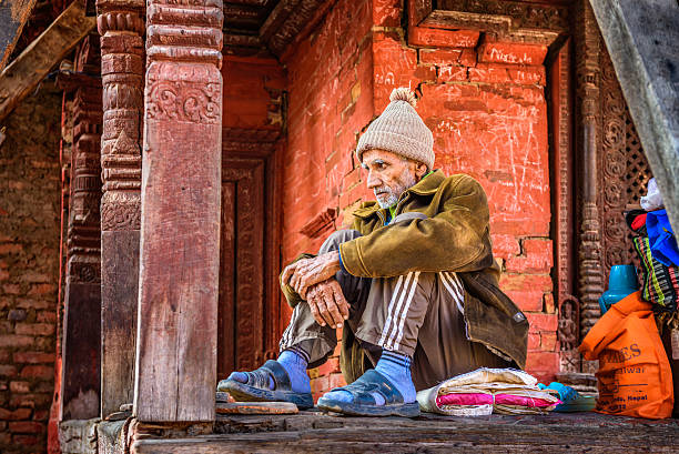 Kathmandu, Nepal - October 20, 2015 : Elderly man begging at Pashupatinath Temple complex in Kathmandu