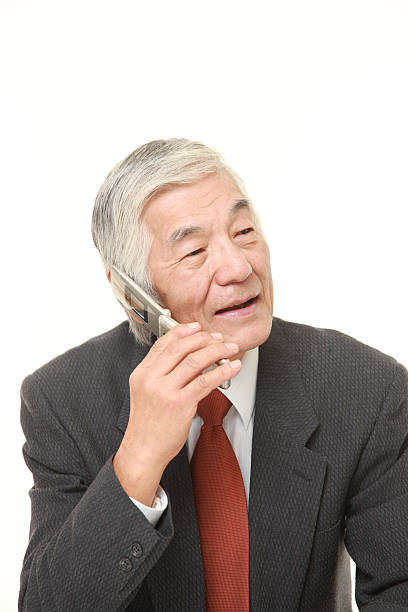 istock senior businessman talks with classic cellphone 500547420