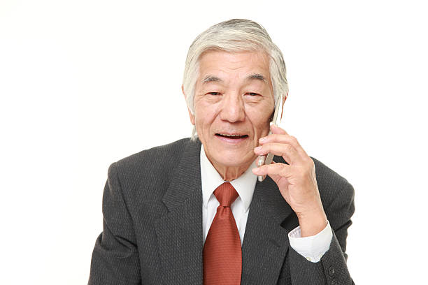 studio shot of senior Japanese businessman on white background
