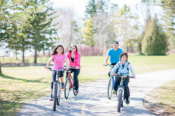istock Family Riding Bikes Through Park 500548822