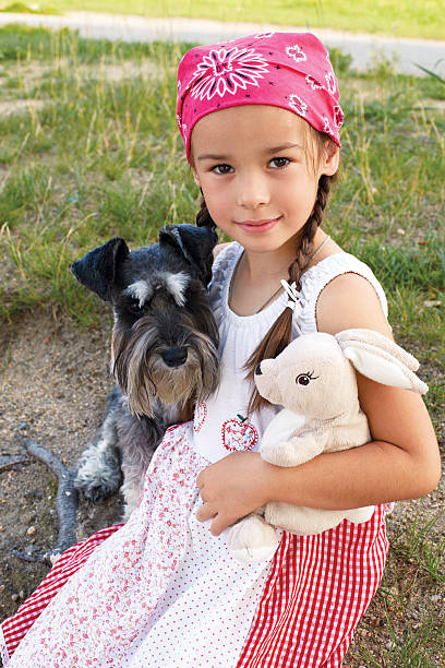 istock little girl hugging her dog 500553775