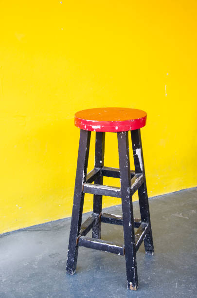 istock Red wooden chair in front of yellow wall 500558043
