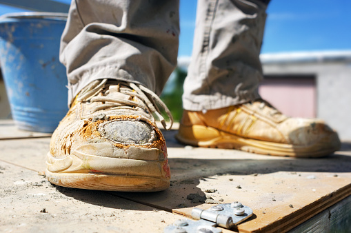 Close-up of construction worker work boots.