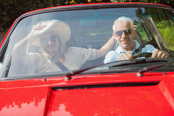 istock Cheerful mature couple in red cabriolet 500559513