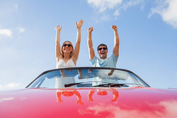 istock Crazy couple standing in red cabriolet 500559525