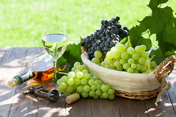 istock White wine bottle and glass, red and white grape 500569314