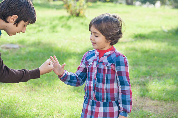istock Children play rock-paper-scissors on grass 500572964