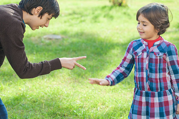 istock Children play rock-paper-scissors on grass 500573346