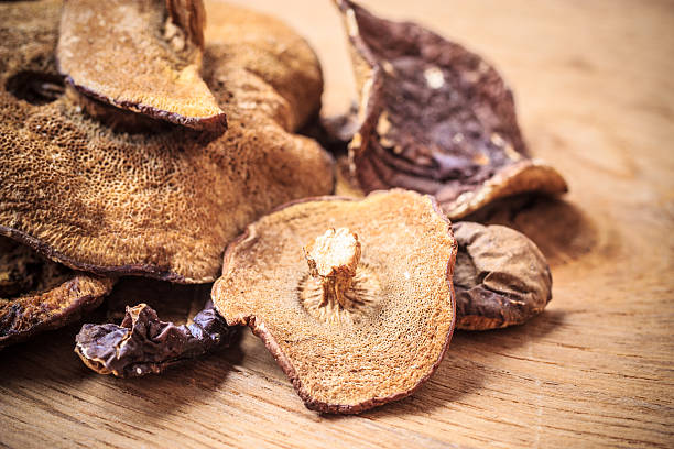 istock Dry mushrooms on wooden rustic table. 500573584