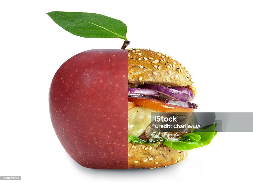 Healthy and unhealthy food lifestyle choices concept Healthy apple and unheatlhy burger merged into one over a white background Healthy Eating Stock Photo