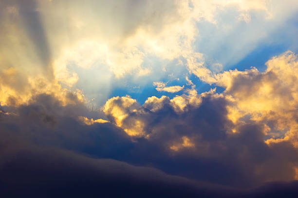 istock Dramatic sunset with golden sun rays among the clouds 500575223