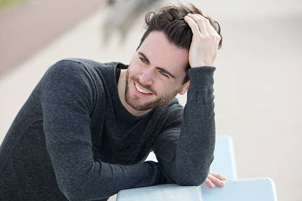 istock Attractive man smiling with hand in hair 500577271