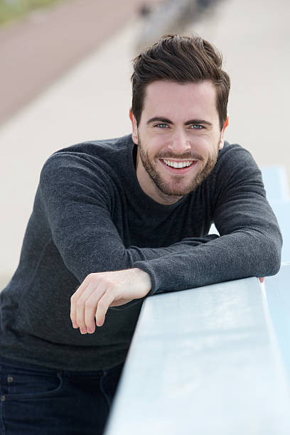 istock Friendly young man smiling outdoors 500577273