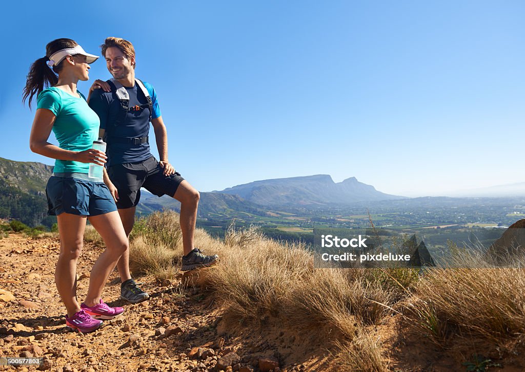 The view's always better when we can share it A full length shot of a sporty young couple standing on a mountain path and admiring the viewhttp://195.154.178.81/DATA/i_collage/pu/shoots/784344.jpg Active Lifestyle Stock Photo