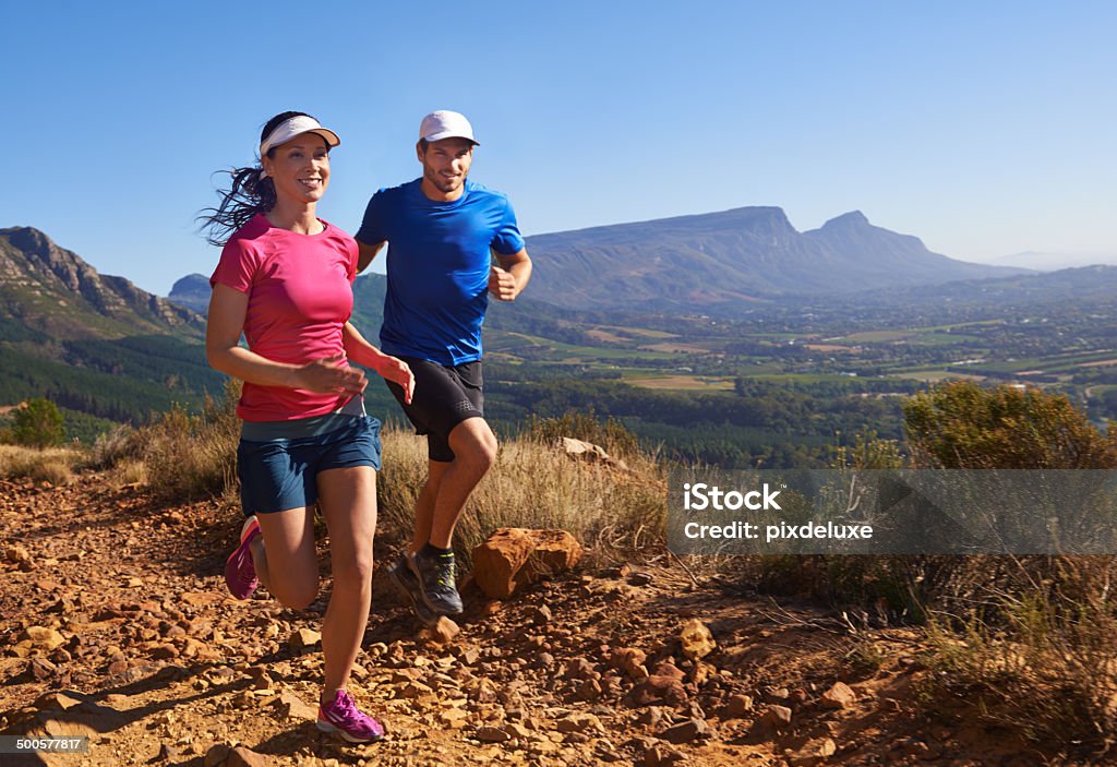 WARNING: Exercise has been known to cause health and happiness A full length shot of a happy young couple running along a scenic mountain path togetherhttp://195.154.178.81/DATA/i_collage/pu/shoots/784344.jpg Active Lifestyle Stock Photo