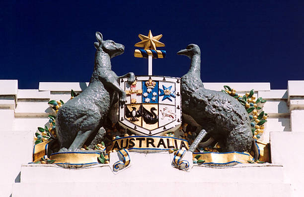 Australian coat of arms, Canberra Canberra (ACT), Australia: Old Parliament House facade detail - Australian coat of arms - shield depicting the badges of the six Australian states, enclosed by an ermine border - supporters are native Australian animals, the red kangaroo (Macropus rufus) and the emu (Dromaius novaehollandiae - Commonwealth Crest - photo by M.Torres red kangaroo stock pictures, royalty-free photos & images