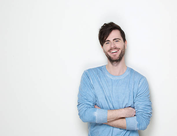 istock Handsome man smiling with arms crossed 500579729