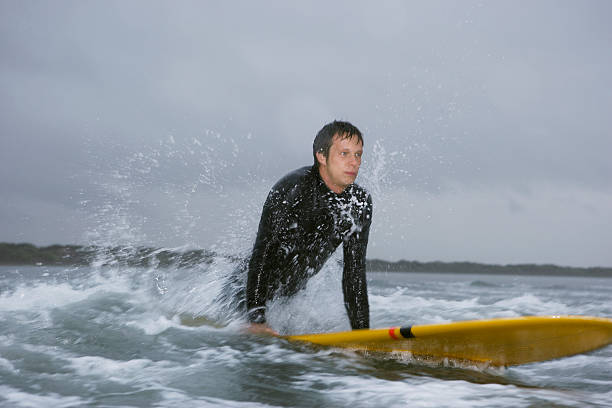 istock Man Looking Away While Surfing In Water At Beach 500580803