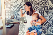 Urban mom balancing work and family in a public cafe.