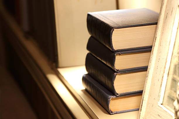 istock four thick books lying on the shelf 500590438