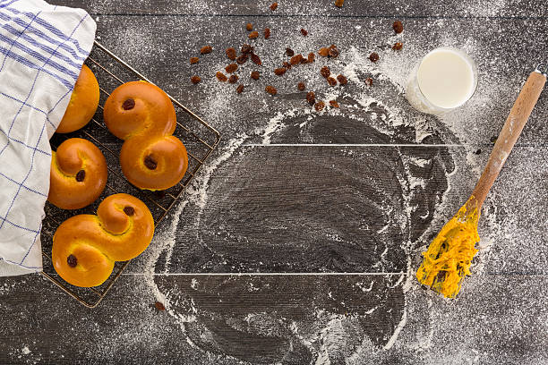 baking of swedish saffron buns. - lussebulle bildbanksfoton och bilder