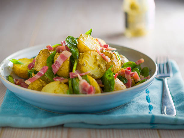 Home made freshness potatos salad with freshness spinach and basil pesto sauce and bacon.