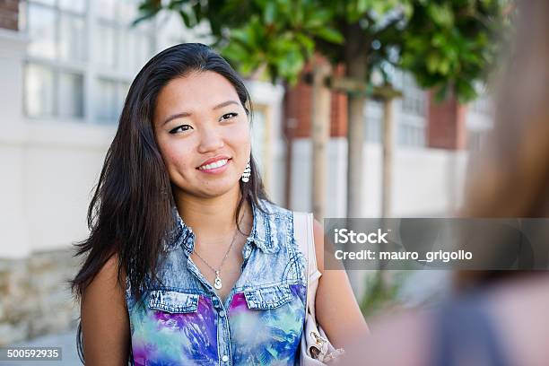 Young Asian Woman Talking With A Friend City Life Stock Photo - Download Image Now - 18-19 Years, 20-24 Years, 20-29 Years