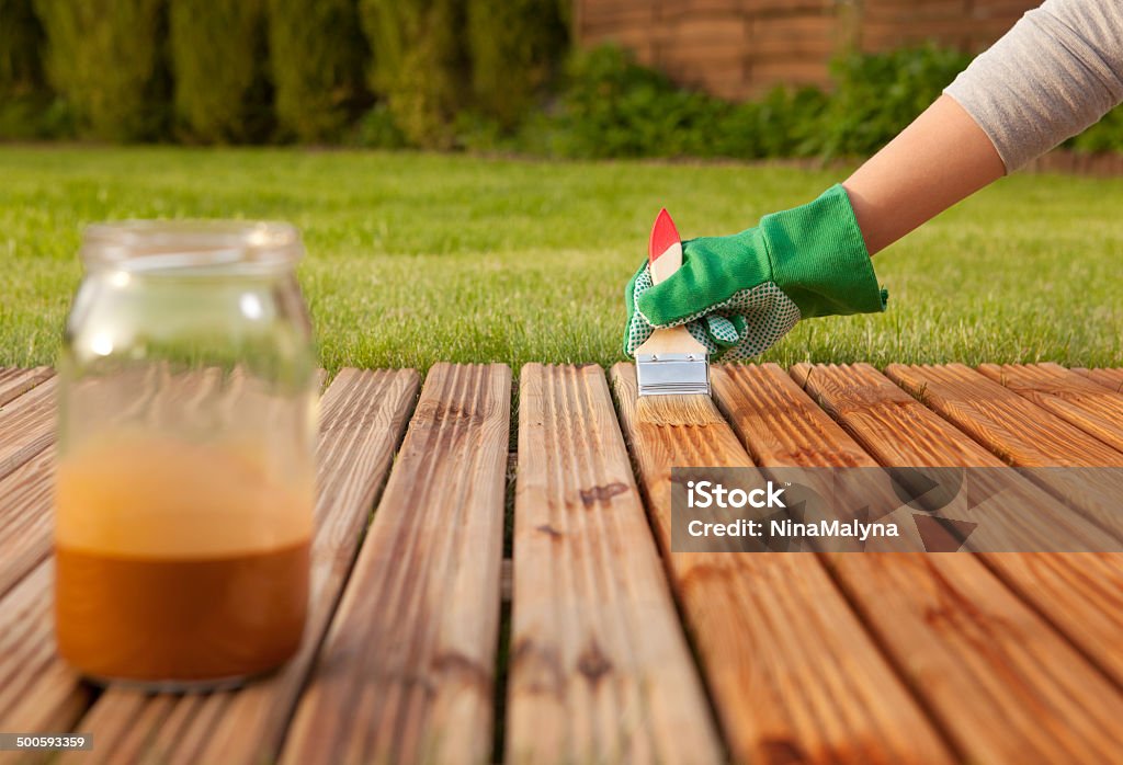 Painting wooden patio deck Painting wooden patio deck with protective varnish  Wood Stain Stock Photo