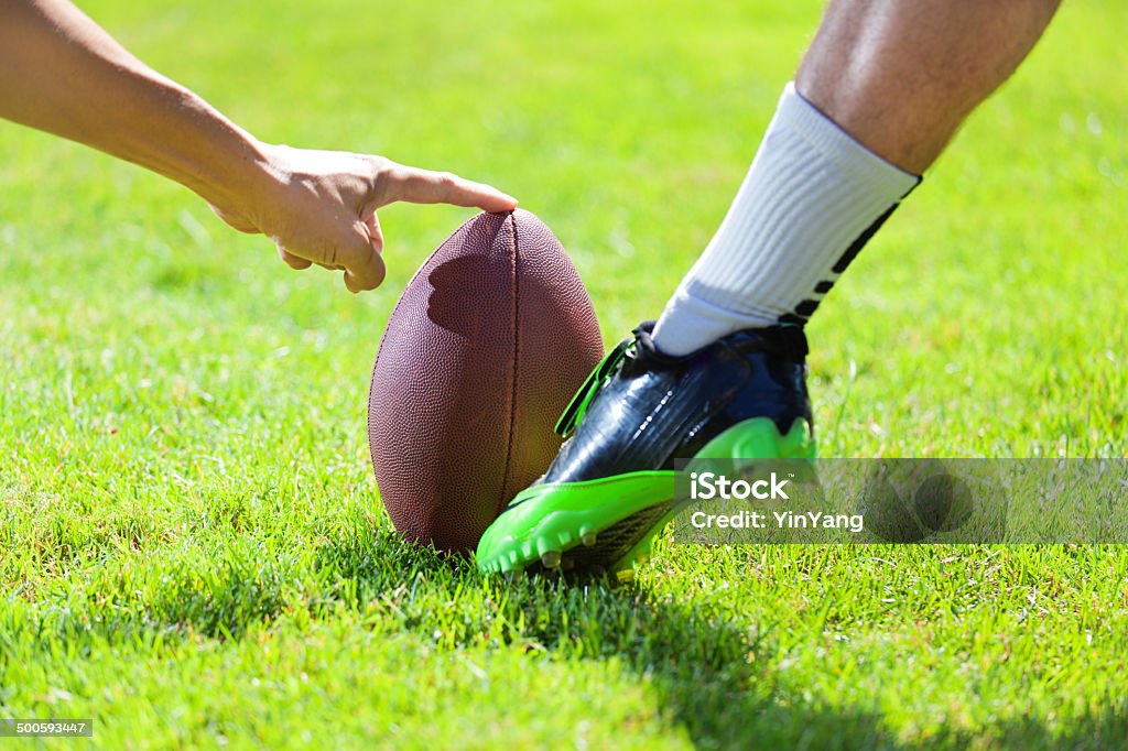 Amrtican Football Player Kicking the Field Goal American football kicking field goal in action. American Football - Ball Stock Photo