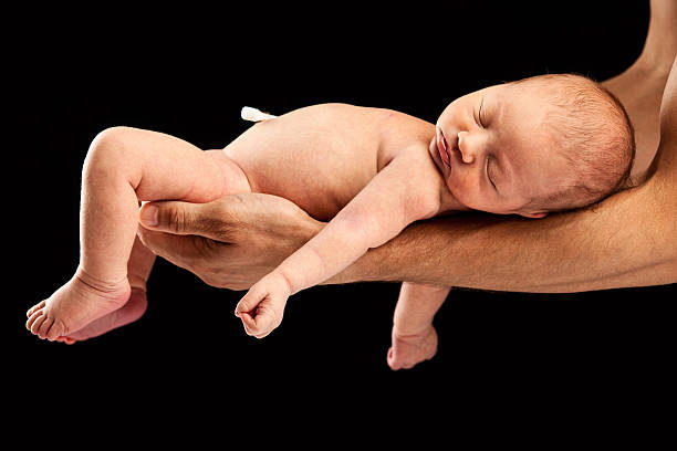 istock Newborn boy lying on his dad's arms 500593738