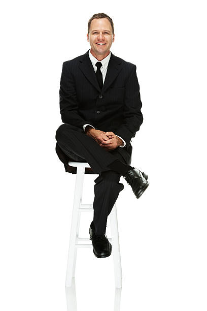 istock Happy businessman sitting on stool 500593935