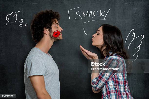 Woman Giving Flying Kiss To Man Stock Photo - Download Image Now - Blowing a Kiss, Couple - Relationship, Valentine Card