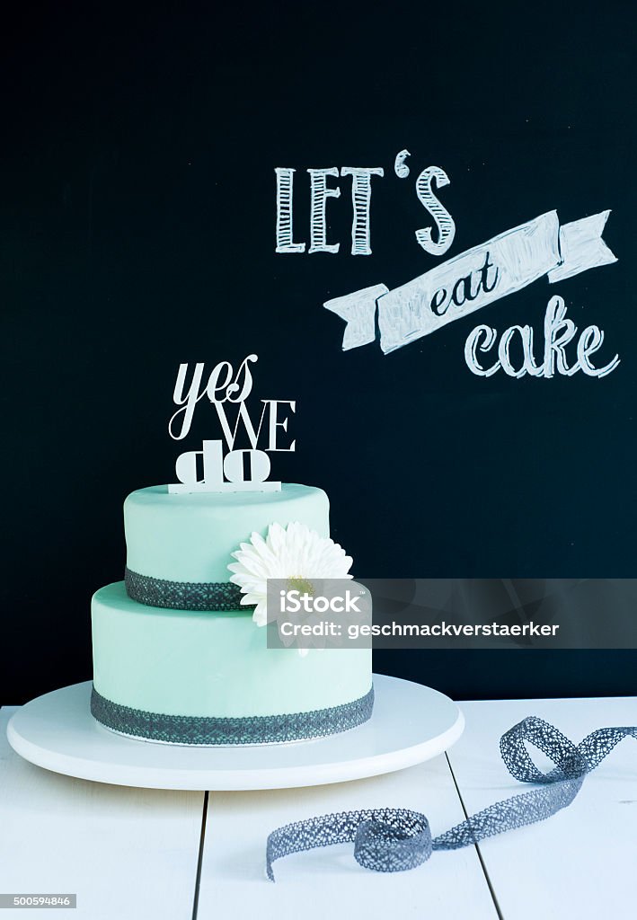 Wedding Cake Mint "Yes we do" Wedding Cake in Mint with a white flower and cake topper "Yes we do" 2015 Stock Photo