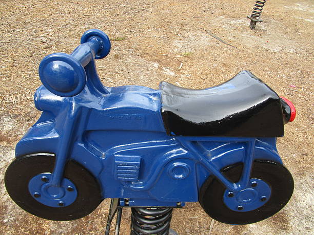 istock MOTORCYCLE-SHAPED CHILDREN'S RIDE AT PARK 500596470