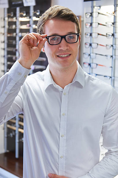 istock Man Trying On New Glasses At Opticians 500598242