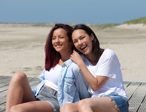 Portrait of a two sisters smiling at the beach
