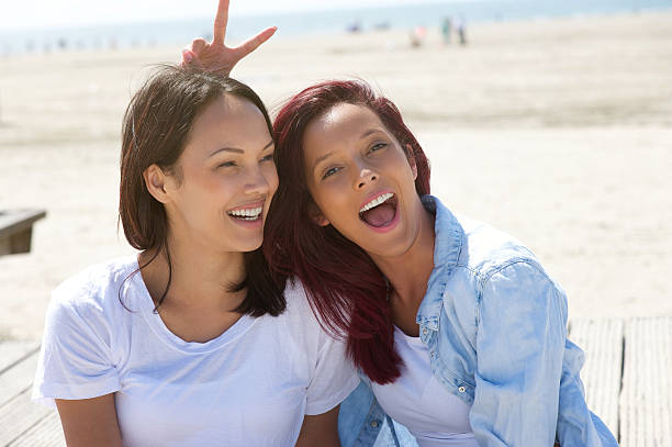 istock Cheerful sisters having fun at the beach 500598669