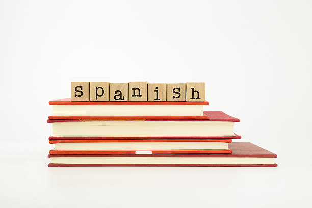 Spanish word on wood stamps stack on books, language and academic concept