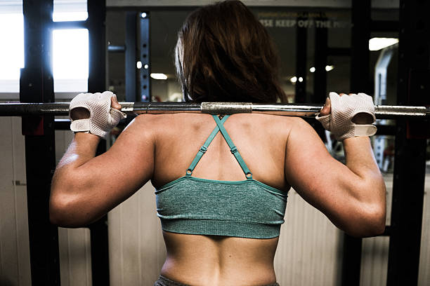 istock Young woman leaning on a squats rack 500599910