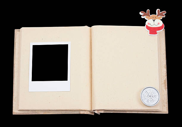 Open photo album Open christmas photo album on black background. old black leather photo album stock pictures, royalty-free photos & images