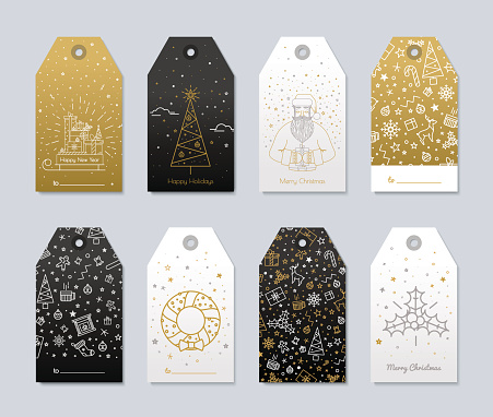 Set of New Year and Christmas labels for gifts. Luxury gold color and black with presents and snow for the congratulations.
