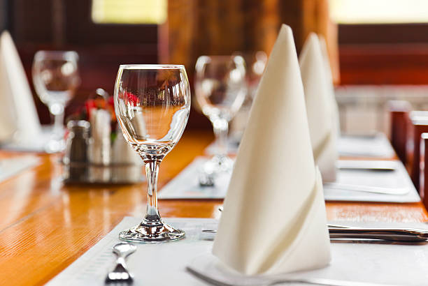 istock Glasses and plates on table in restaurant 500604314