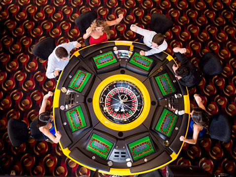 Group of people at the casino playing roulette